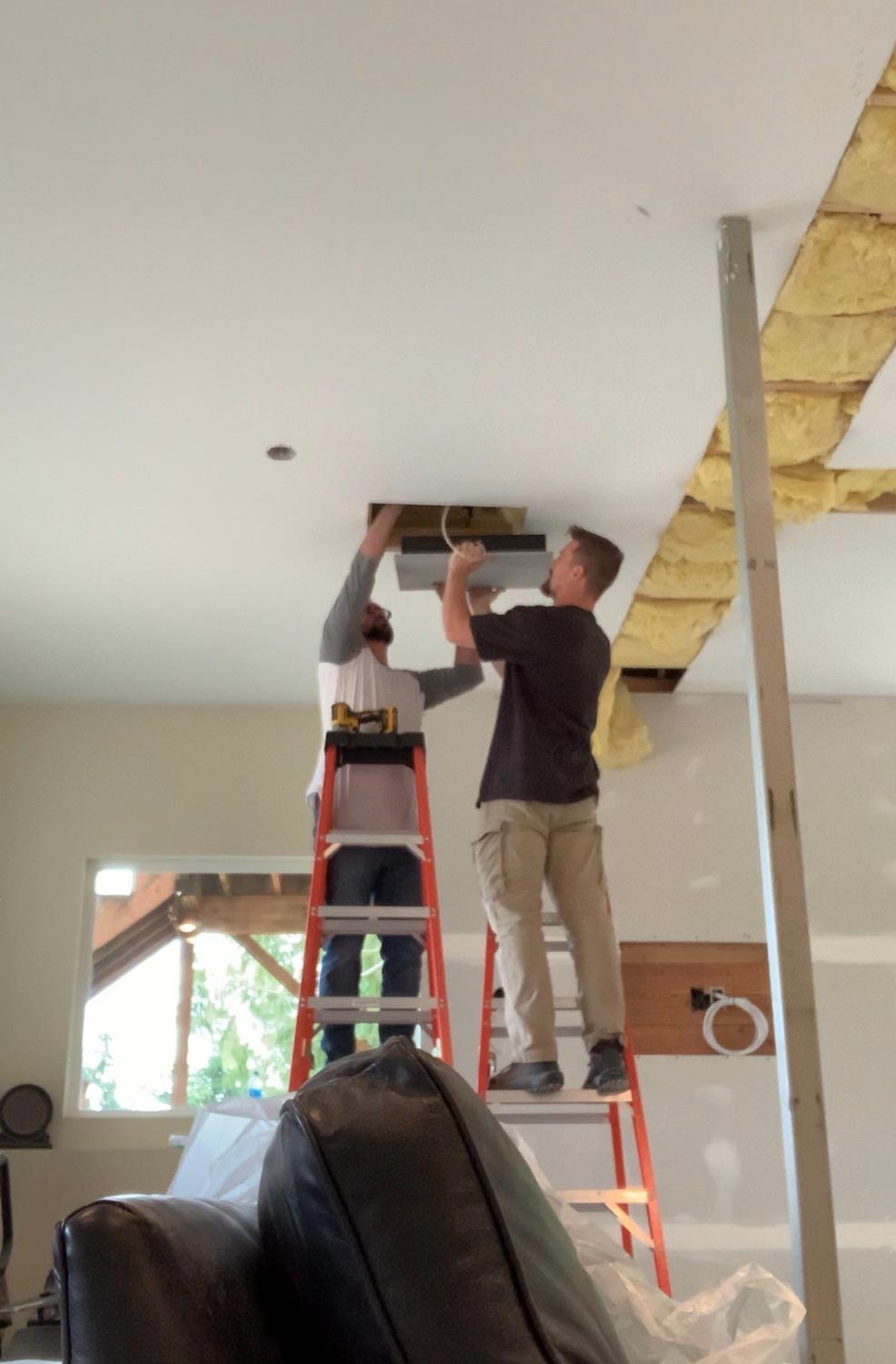 Two men installing lighting