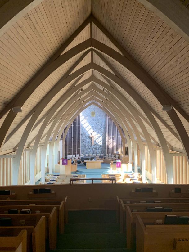 VIew of entire church with wooden beams on ceiling