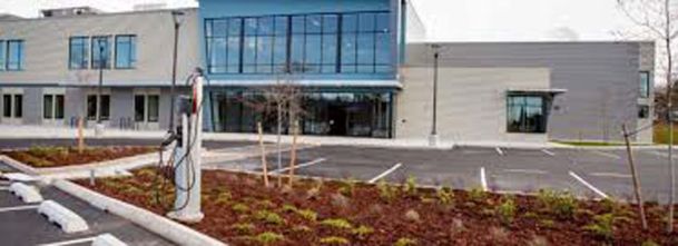 Parking lot view of building with electric charger