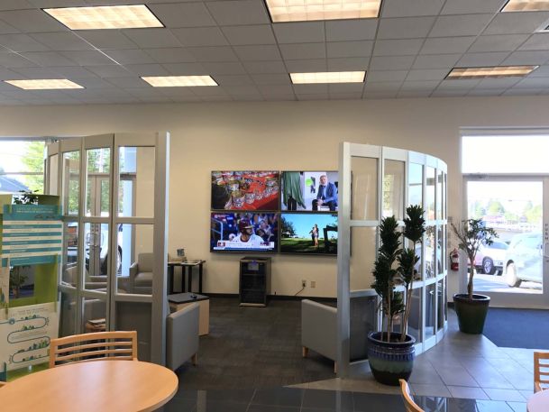 Open concept office space, tv, curved glass walls