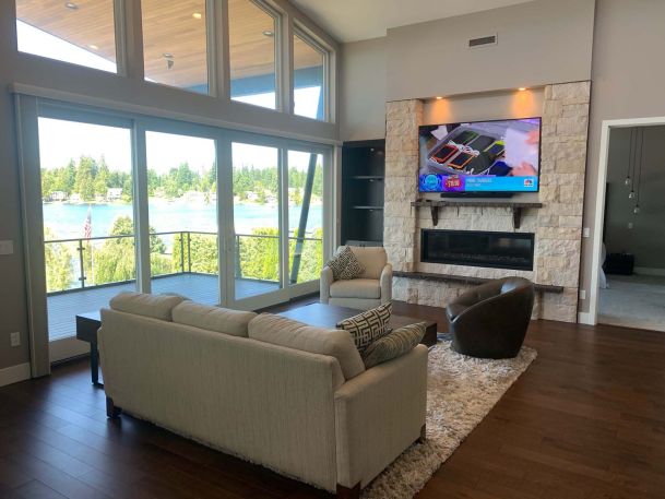 Living room, couch facing tv, large windows