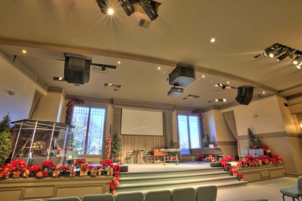 View of church stage, speakers on ceiling