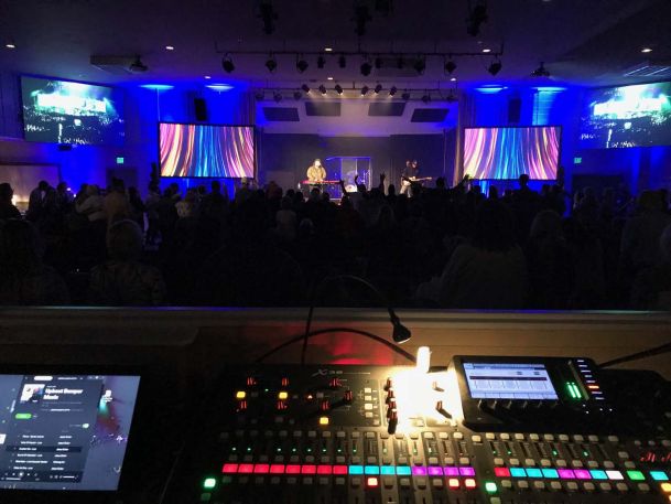 Stage with blue lights and people in it