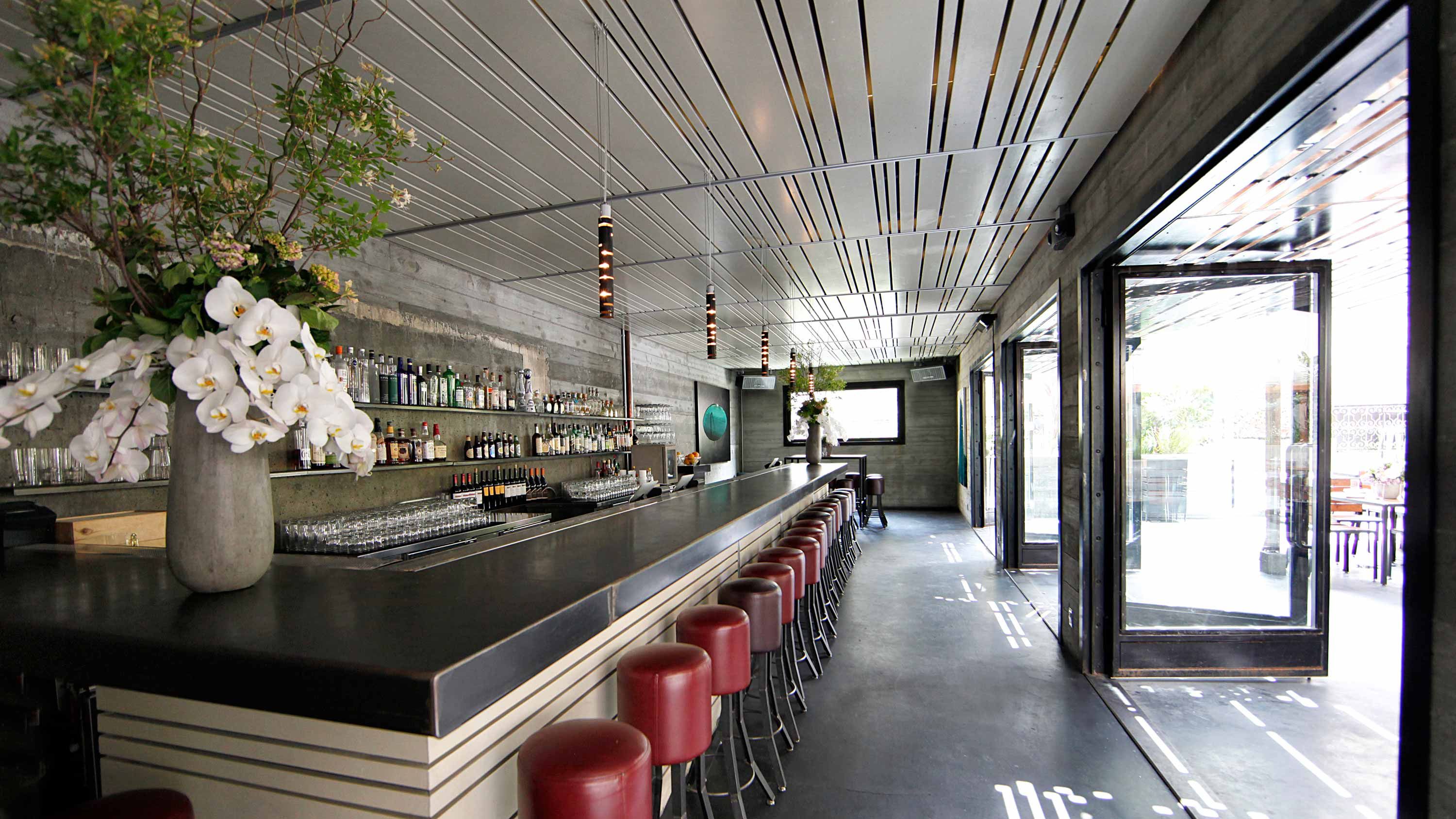 bar with red stools, flowers, restaurant