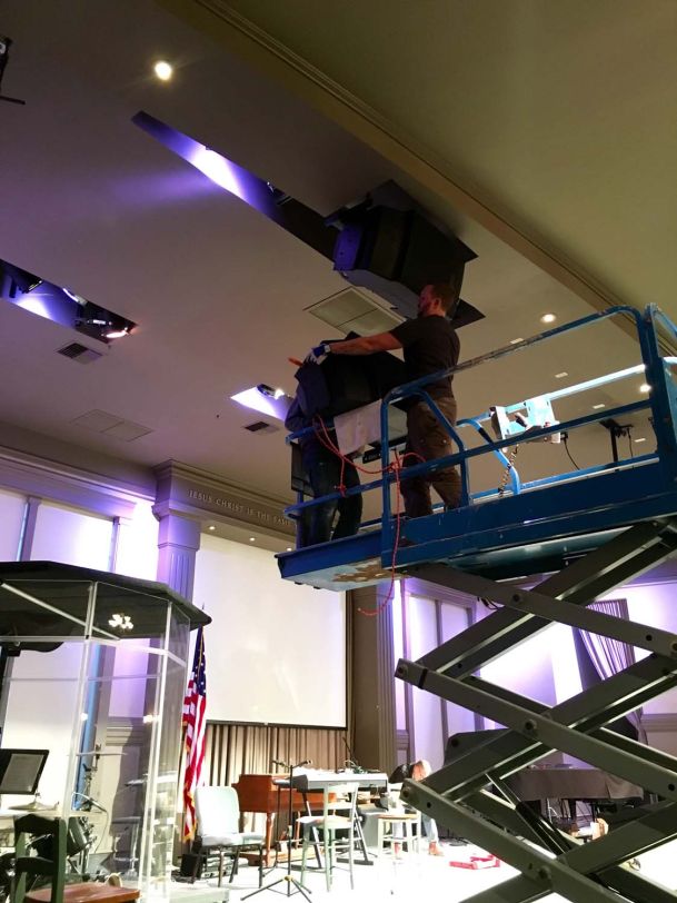 Men working on installing speakers in ceiling